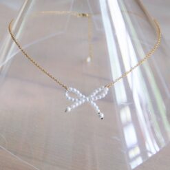 Edelstalen fijne ketting met parelstrik - goud