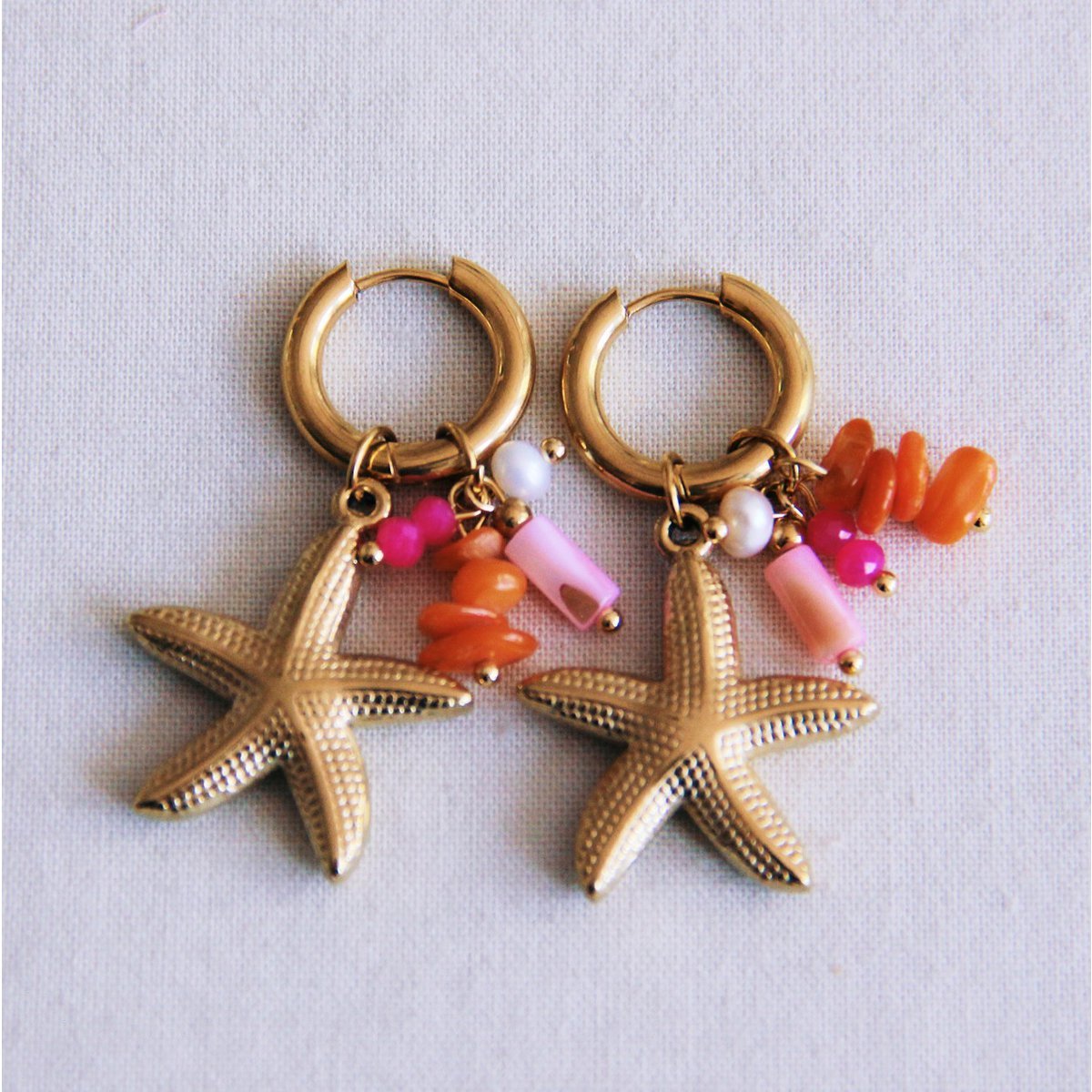 Oorrel met cluster van edelstenen en zeesterren